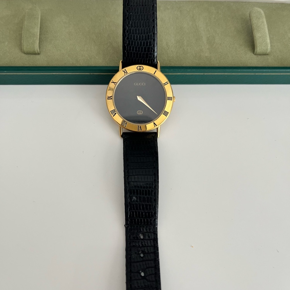 Gucci Black and Gold Timepiece